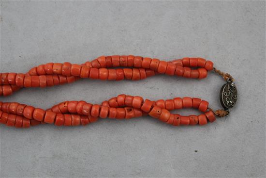 A Chinese double strand coral bead necklace, 24in.